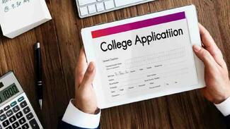 person filling in a college application on a tablet