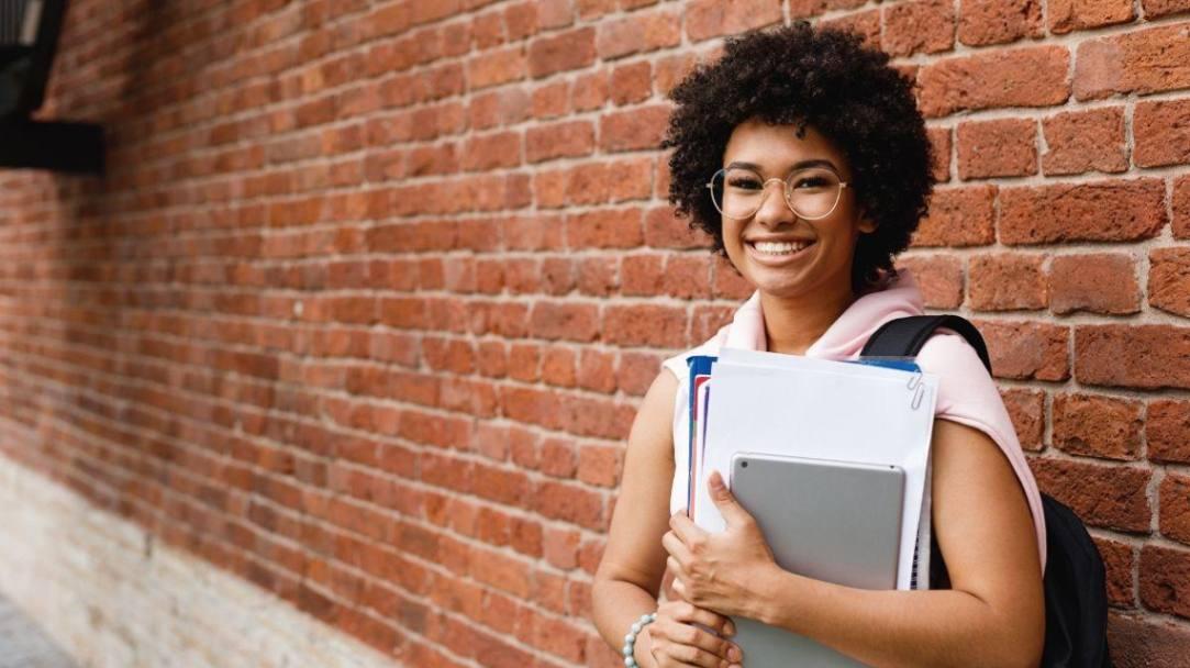 student holding school books