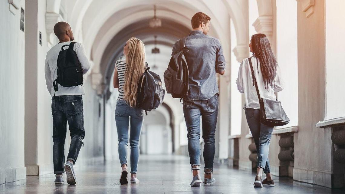 students walking in a university hallway