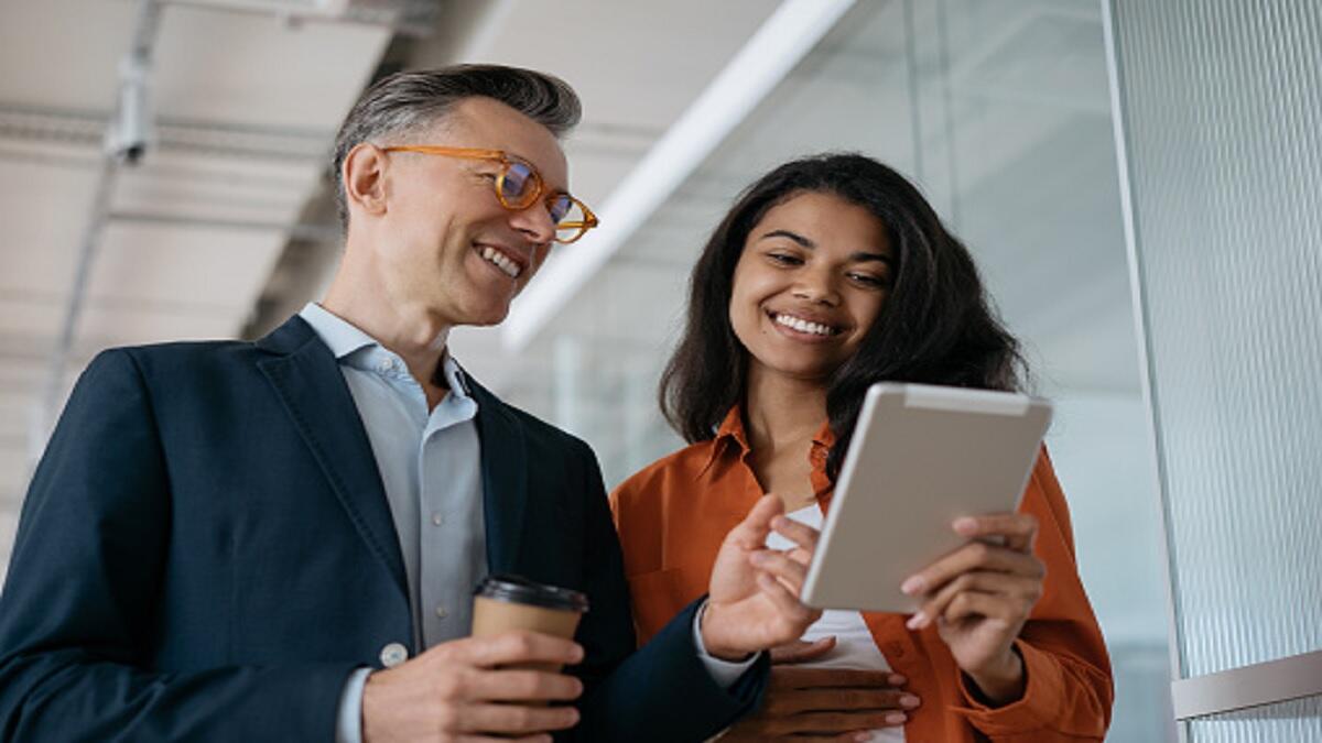 A Human Resources Specialist working with another employee. 
