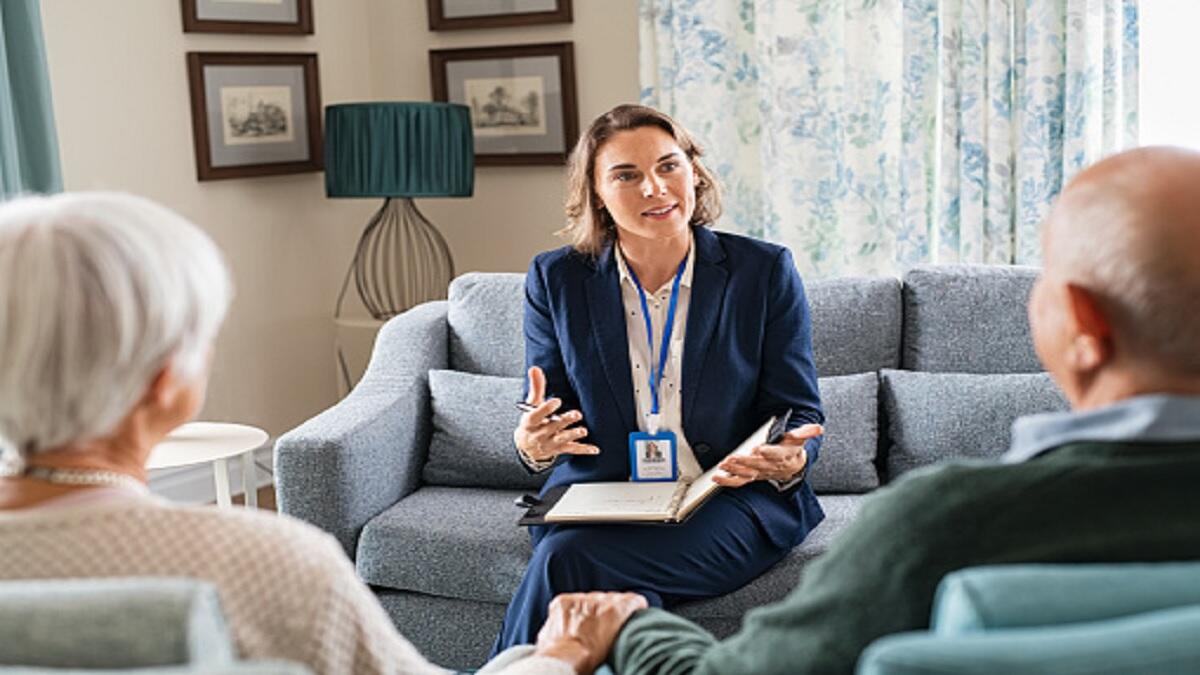 A social worker working with two clients. 