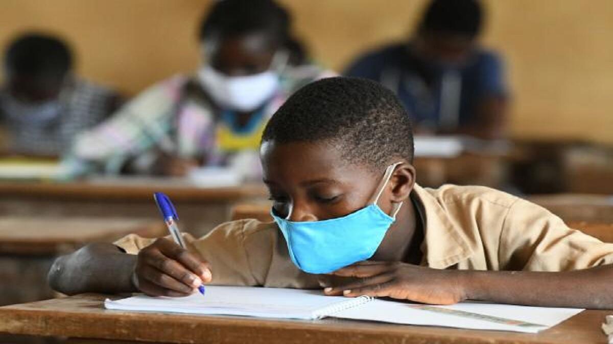 Learners wearing masks in overcrowded classroom