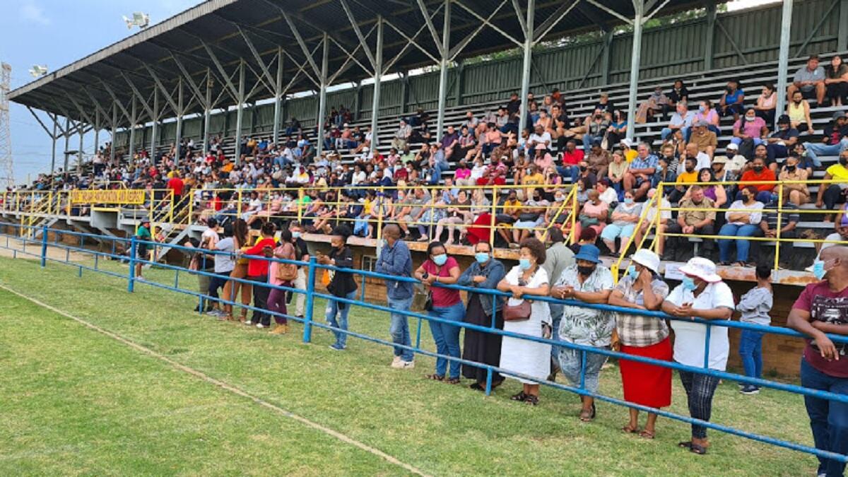 School parents wait for Education Minister in local sports field