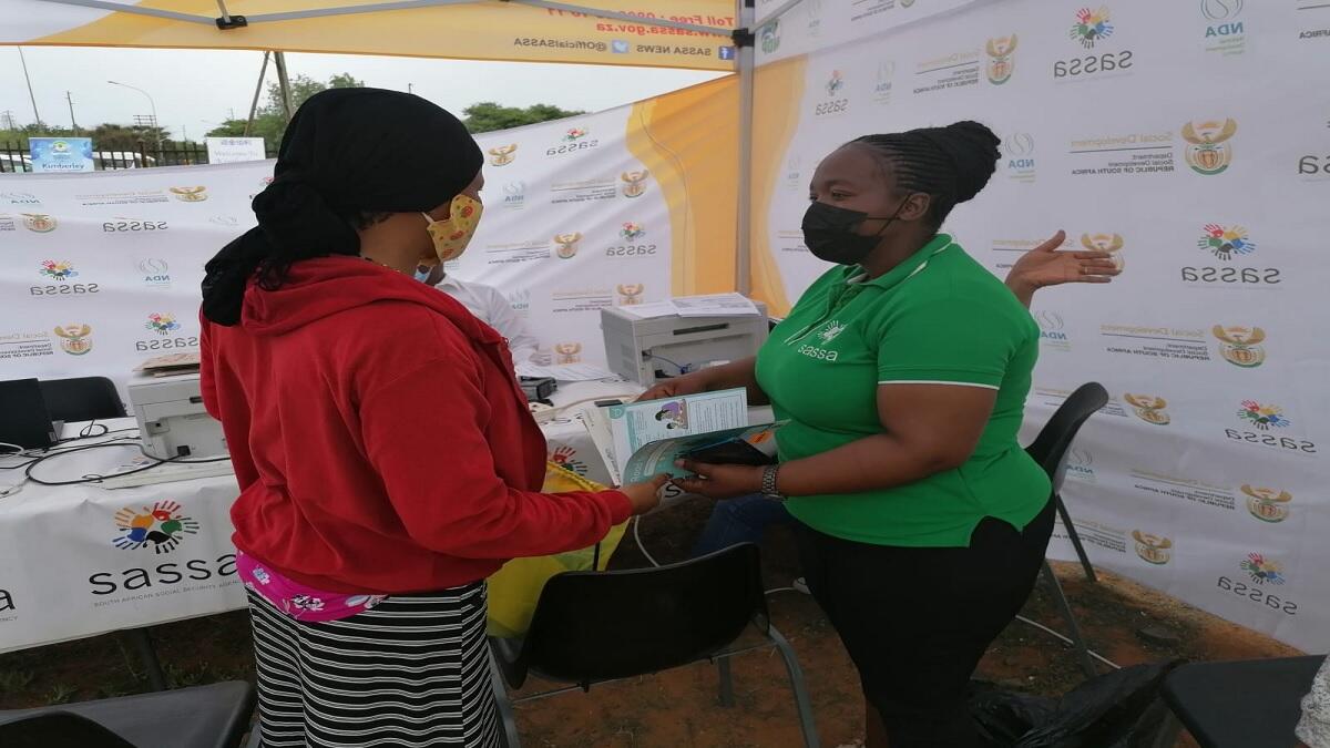 Foster parent being assisted by Sassa official to apply for grant