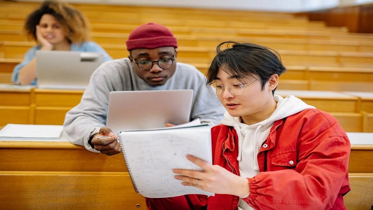 students reading student loan application forms