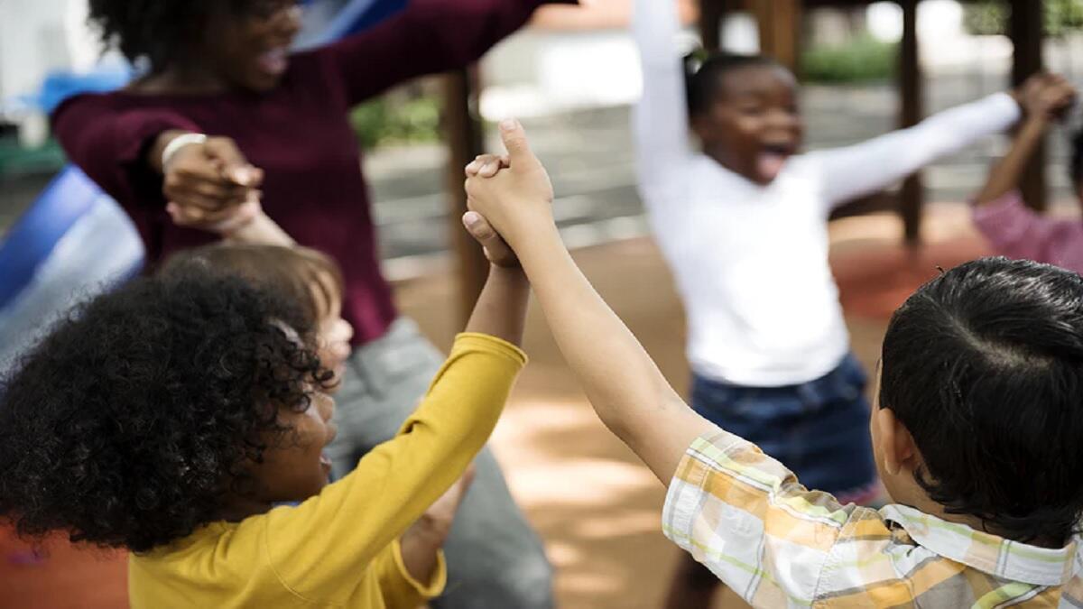 New learners happily enter the gates of the new school
