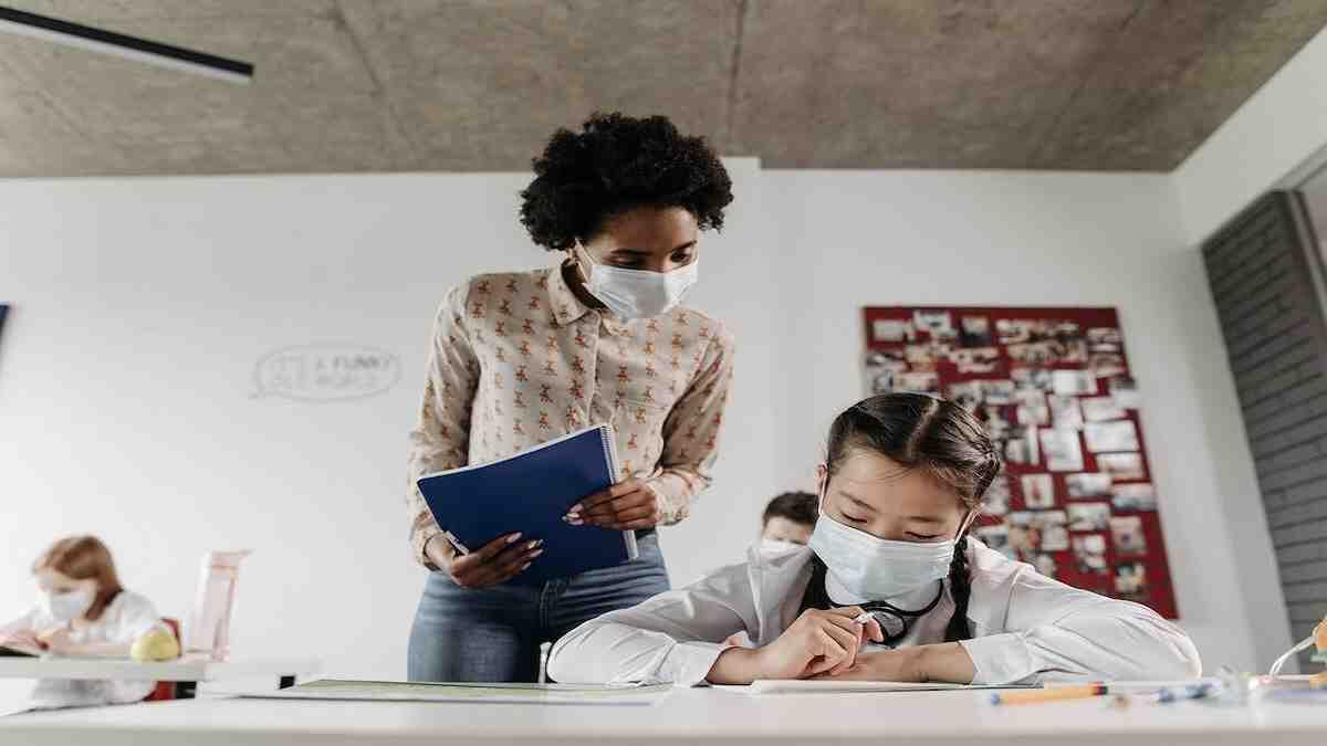 Former teacher assistant looking after learners in class