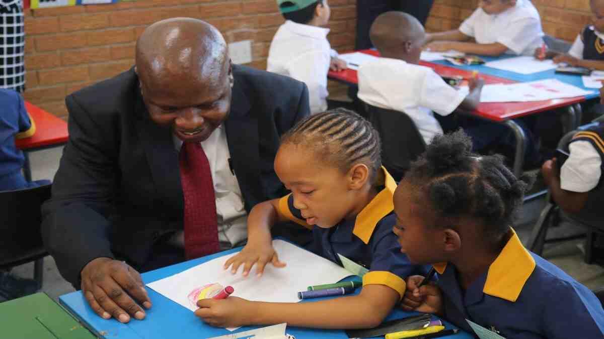 Western Cape grade 1 learners writing on a piece of paper
