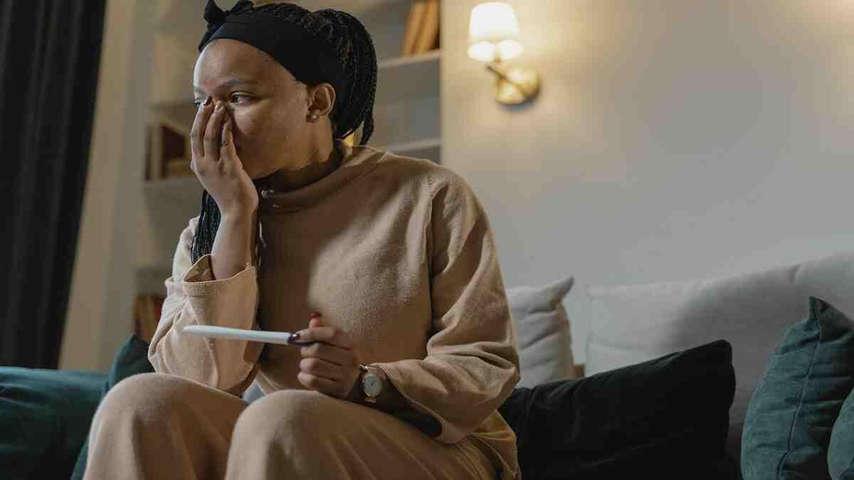 adolescent girl holding pregnancy test