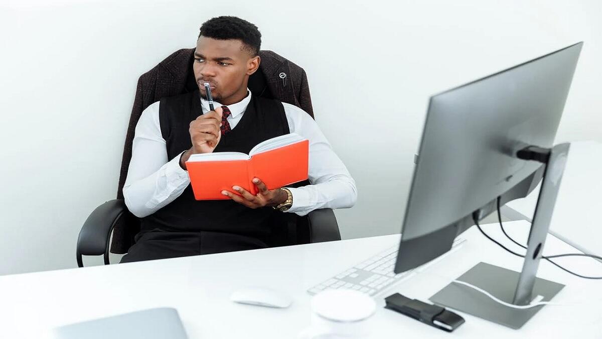 Person looking for Business Management jobs using laptop