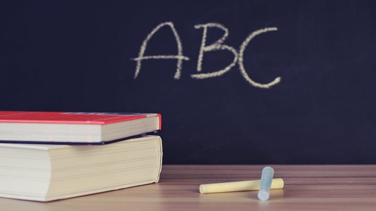 Books to teach new learners on top of wooden desk