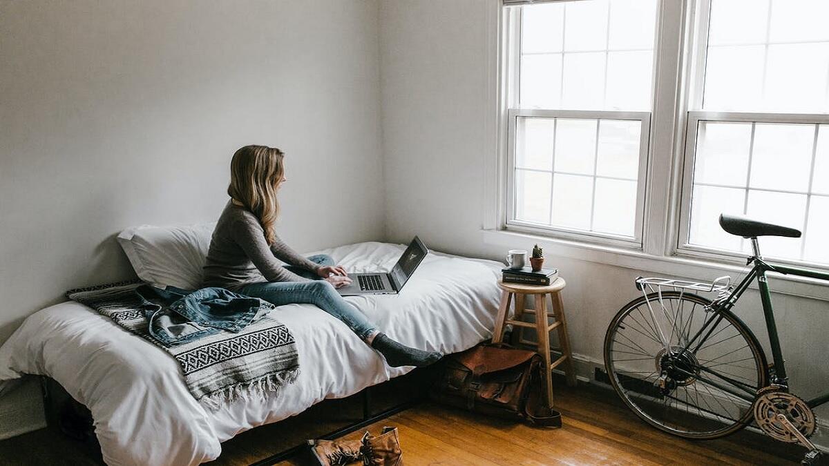 student studying in her room in the university's private residences