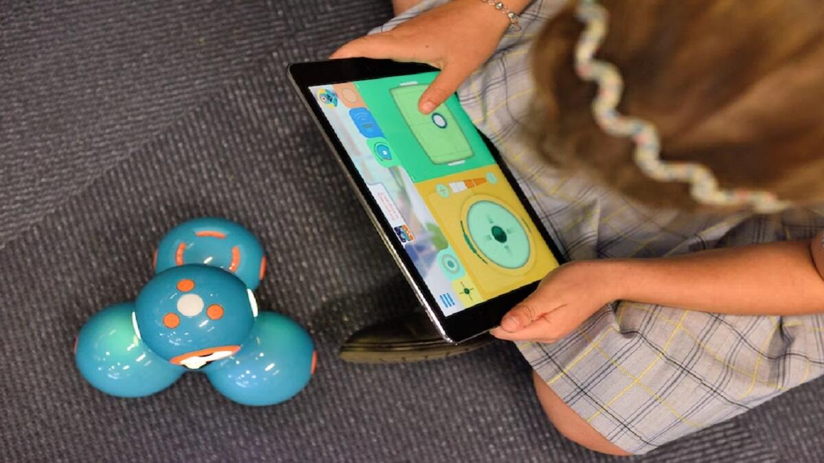 School learner doing coding and robotics on a smart device