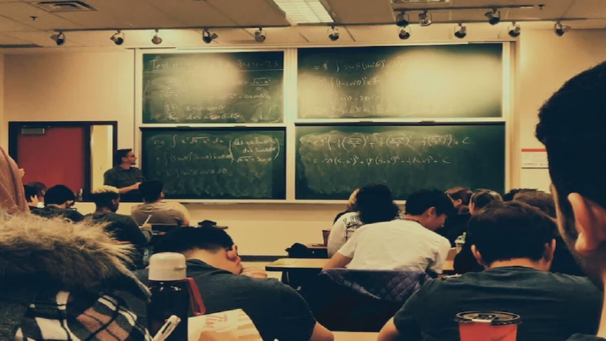 Grade 9 classroom doing math from a chalkboard 