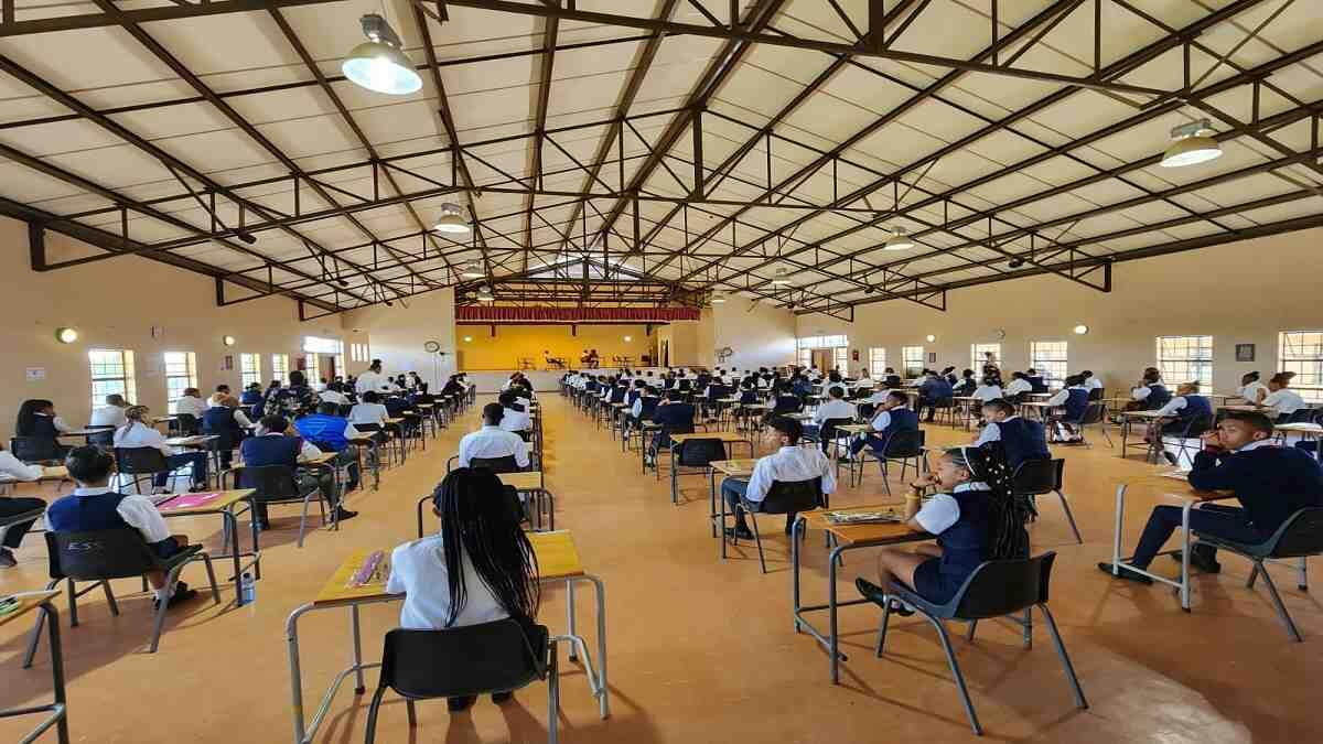Matrics writing their final National Senior Certificate examinations in a school hall