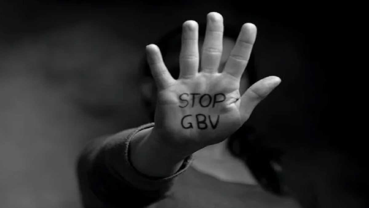 A woman holding her hand up with the message 'Stop GBV'