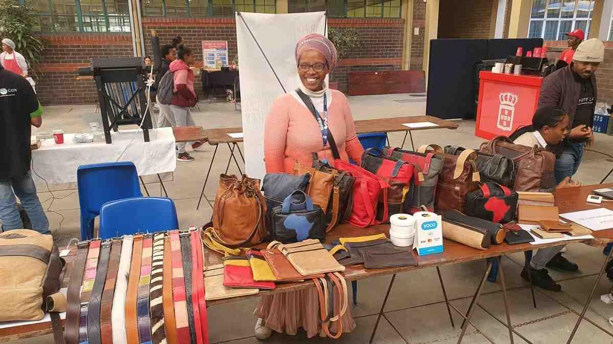 An entrepreneur displaying their hand-made leather products