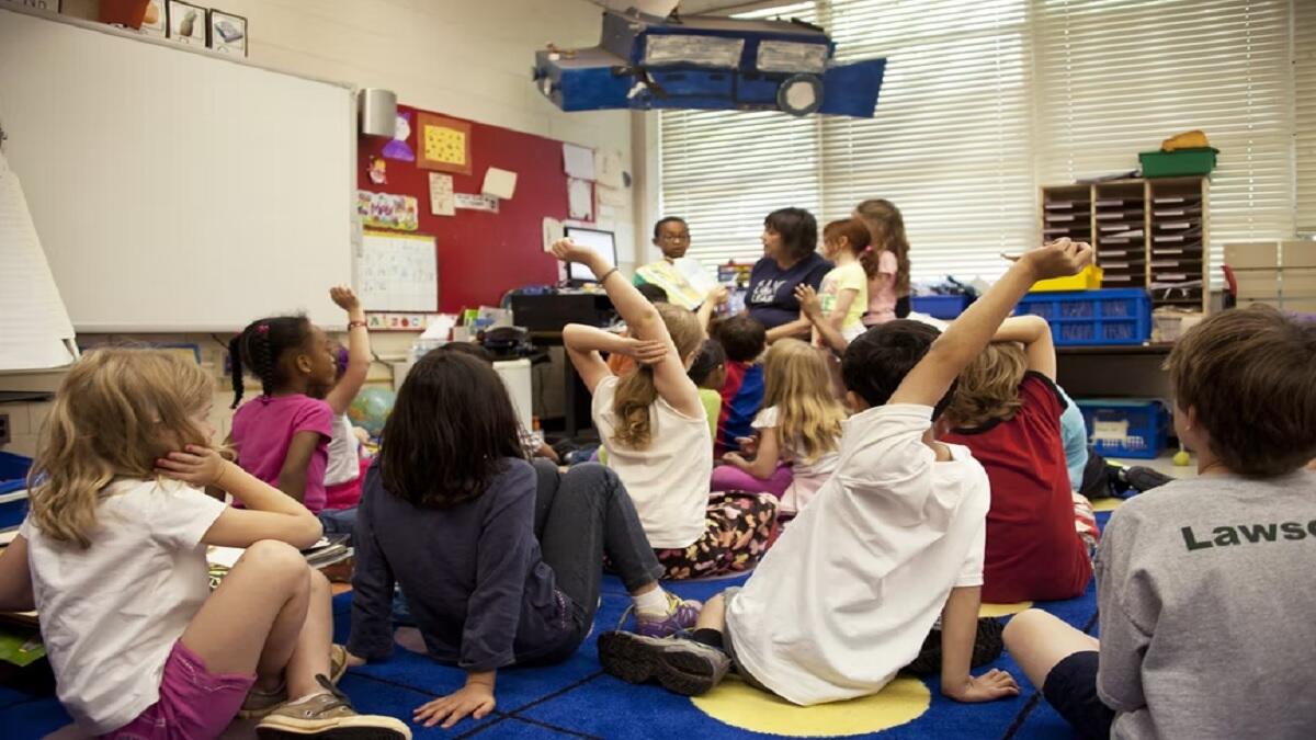 Teacher Assistant helping students in the classroom 