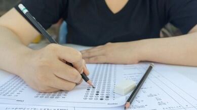 student practices past paper at her desk at home