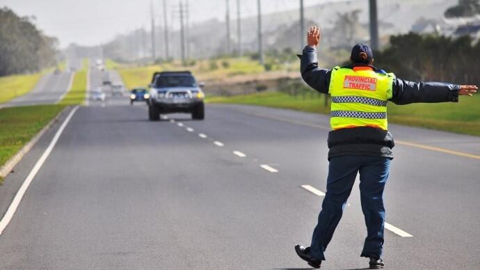 A traffic officer directs an approaching vehicle