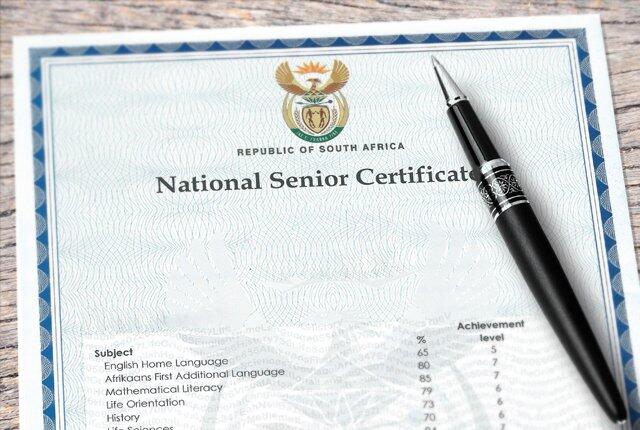 Matric certificate document with a pen placed on its right side. 