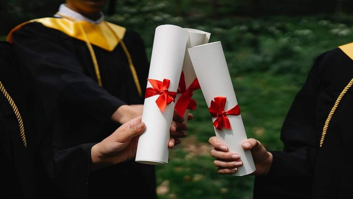 People holding white diplomas