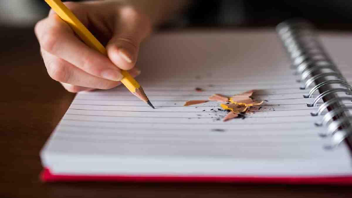 learner taking notes with pencil