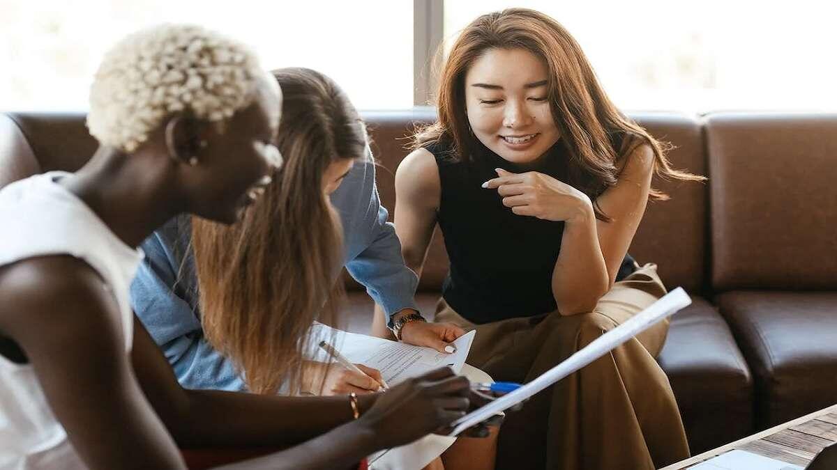 Colleagues talking and working with documents