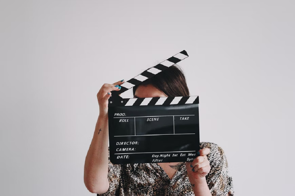 Woman holding take clipper board