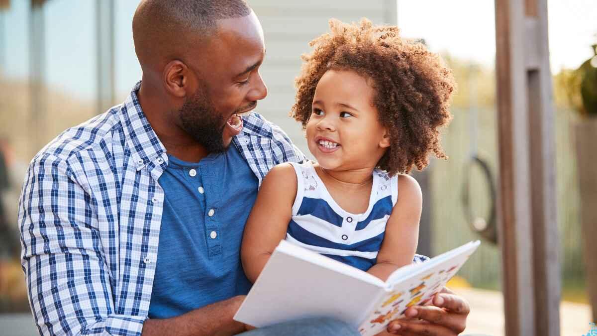 Father reading to daughter 