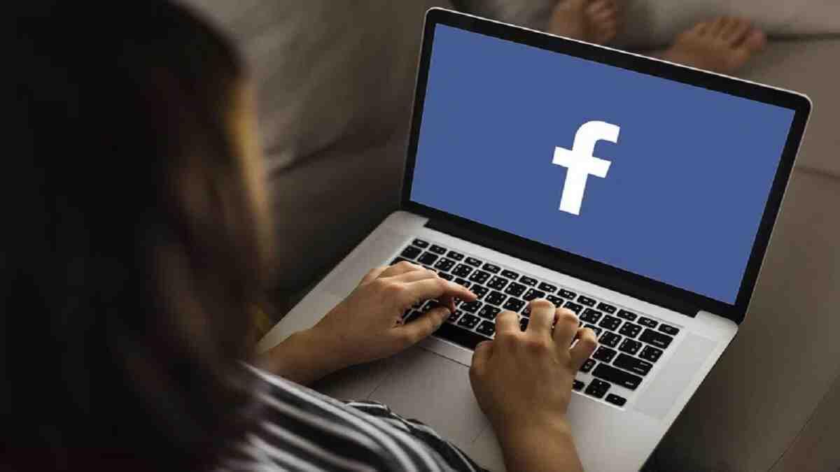 student using facebook on laptop