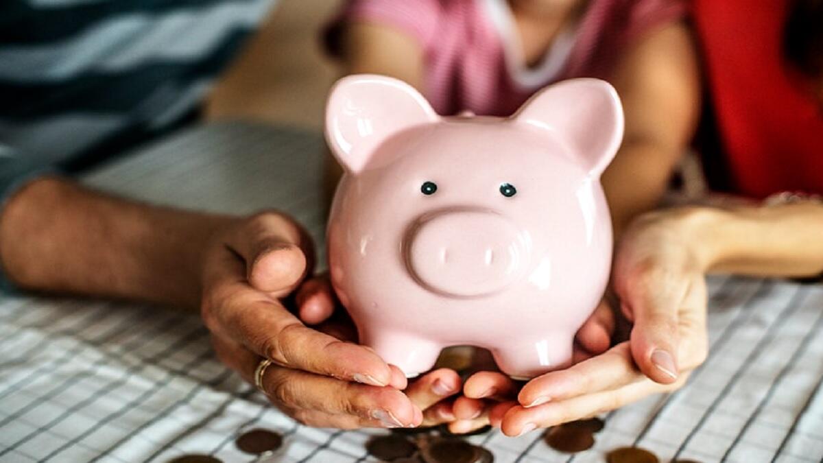 piggy bank in a student's hand for which they will use for funding