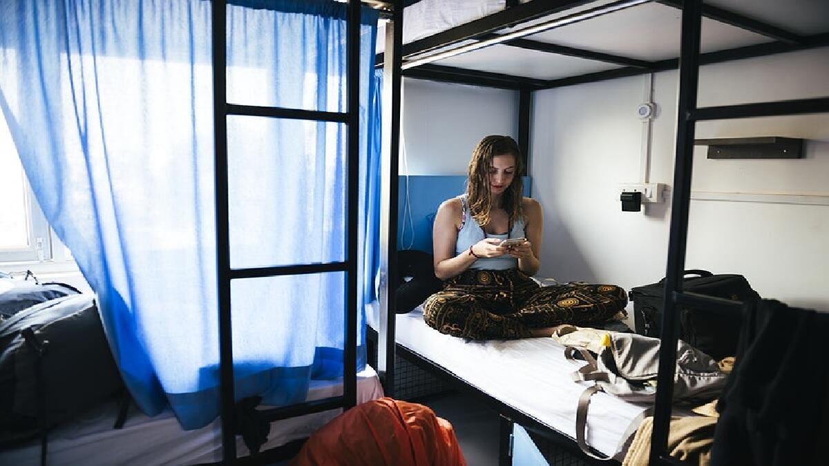 young woman sitting on a bed
