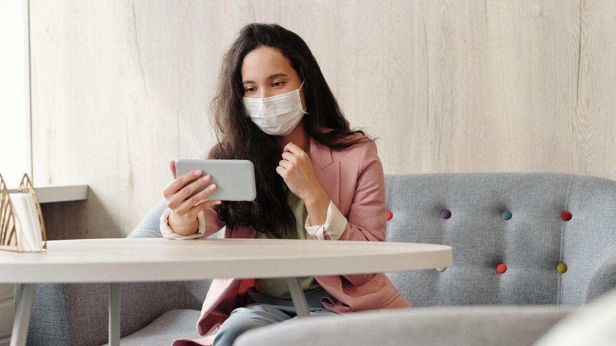 women sitting on her mobile phone