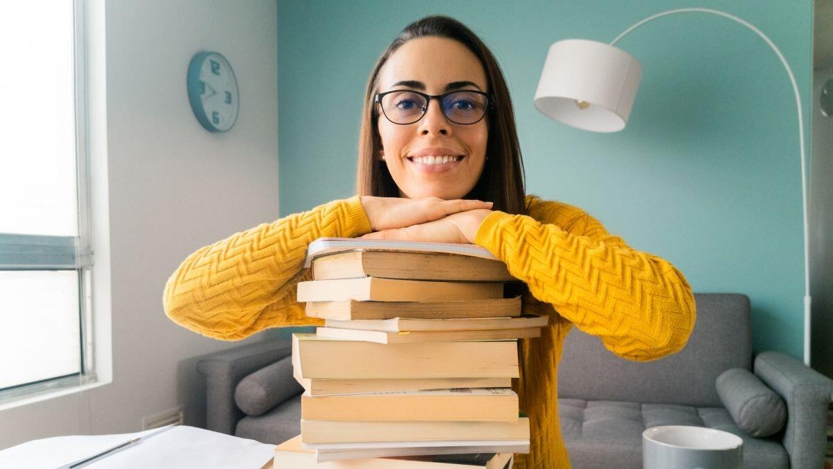 student sitting with hands on her study books