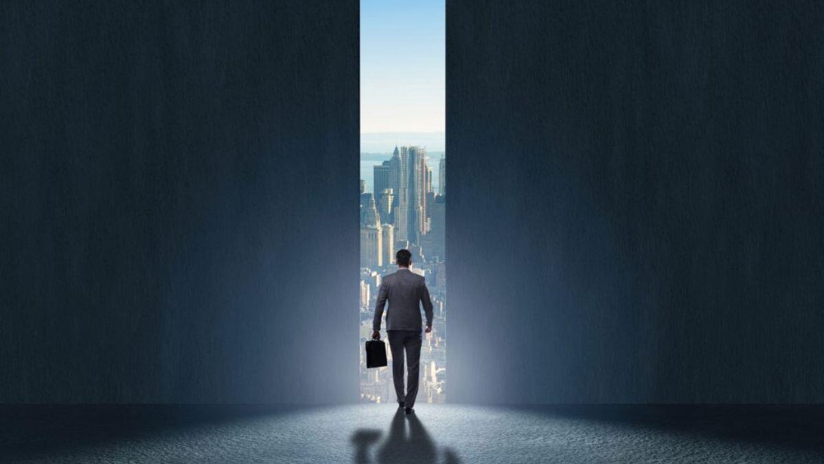 Man walking through a door into the outside