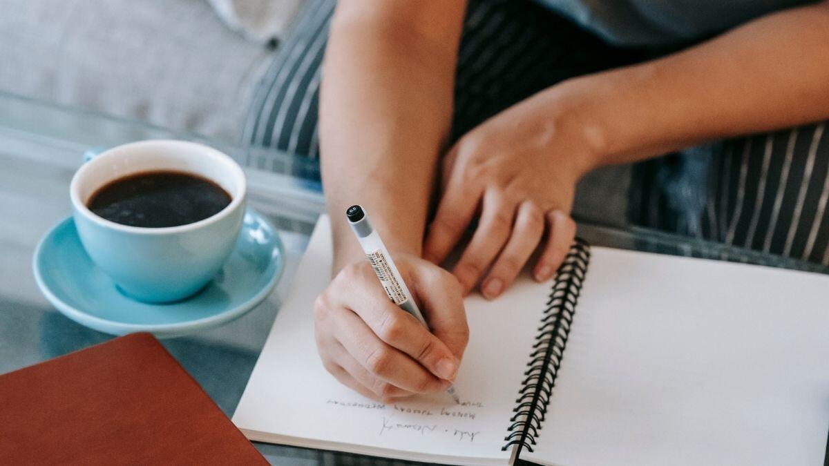 person writing in a notebook