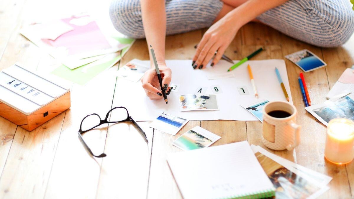 person filling in a vision board