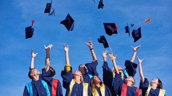 Matric students throwing their hats into the air