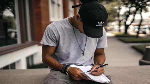 student writing on notebook