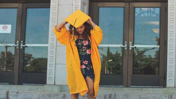 Unisa graduate with academic gown and hood