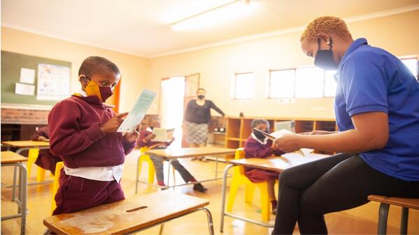 Teaching assistant attending to a learner in class