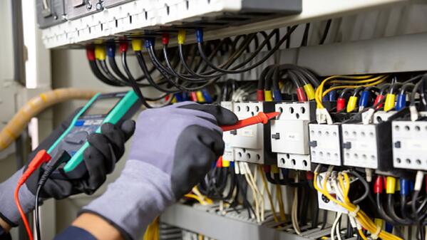 An electrician working with wires.