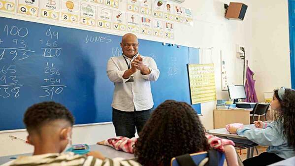A teaching assistant working with school children.