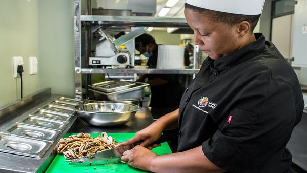 Hospitality students chops mushrooms at the university's hotel
