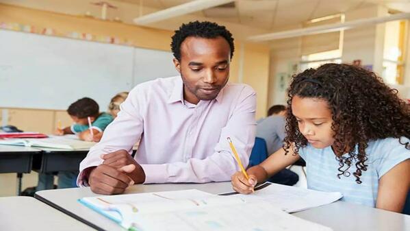 Teacher assistant helps learner with homework