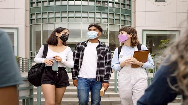 students exiting campus after successful payment of tuition fees through student loan