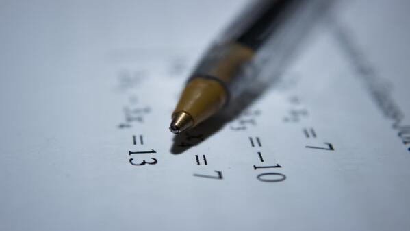 A pen on an IEB Matric Supplementary Examination Maths paper 