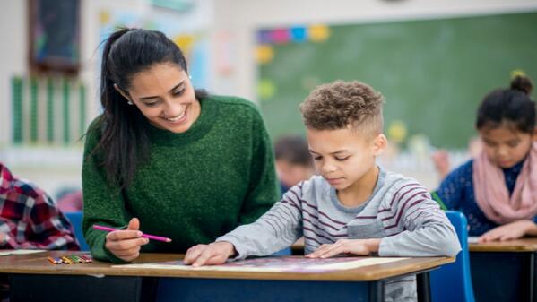 Teacher assisting student in classroom 