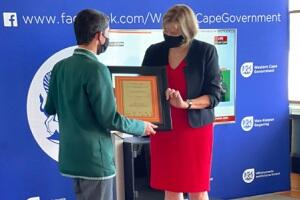 debbie schafer handing an award to a 2020 matric student 